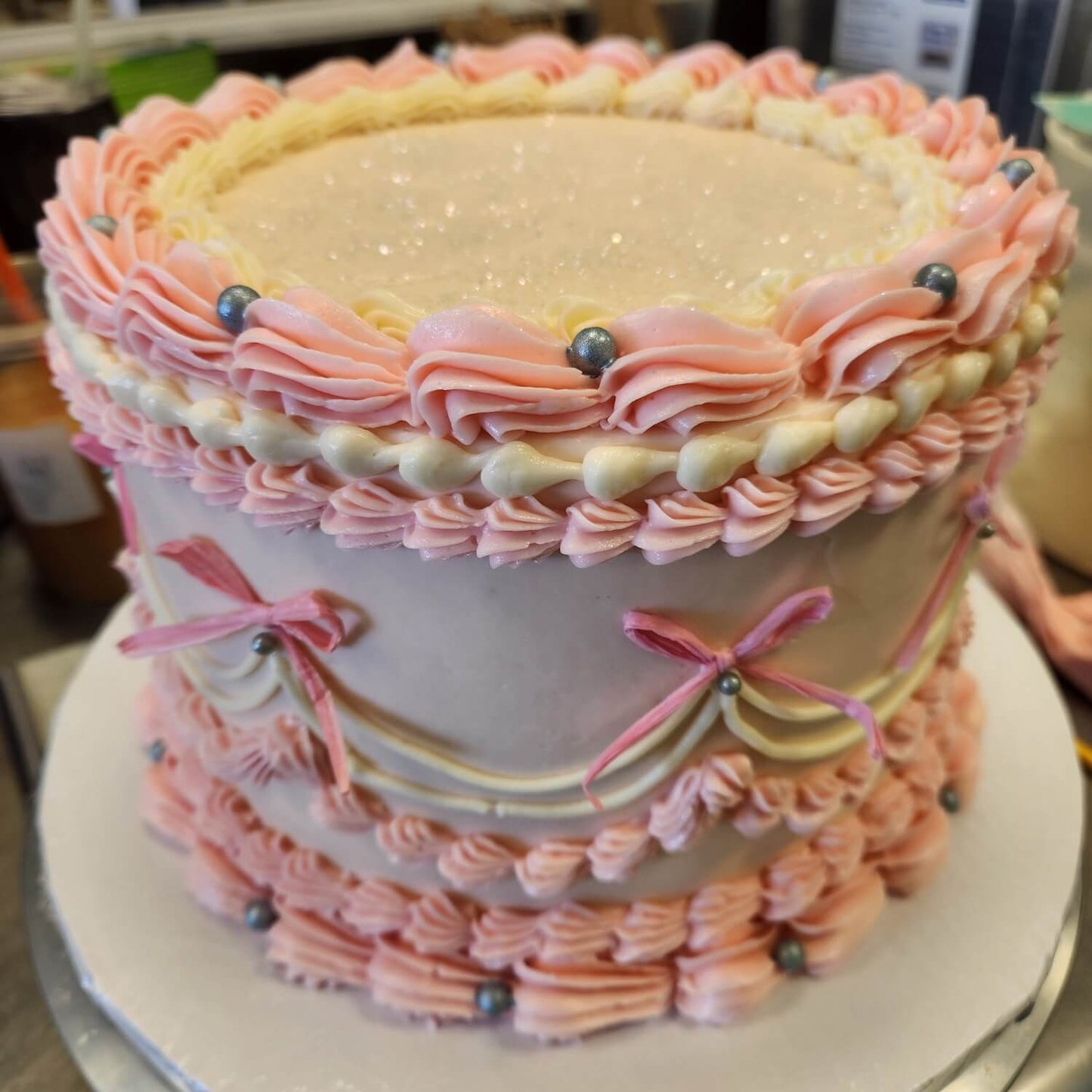 round vintage cake with pink bows.