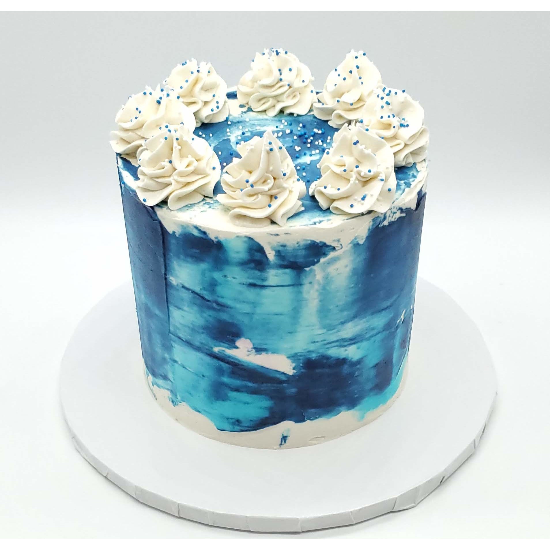 6 Inch Blue Tōn'd Cake with Frosting and Sprinkles on top